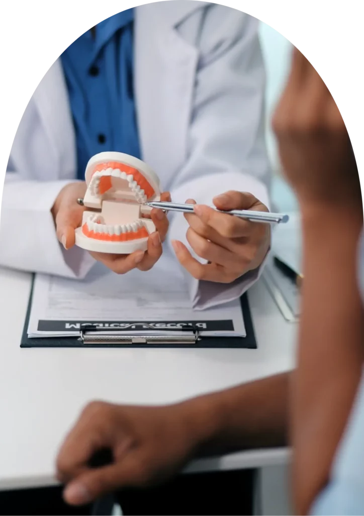 beyondental dentist explaining the dental treatment to the patient using a teeth model